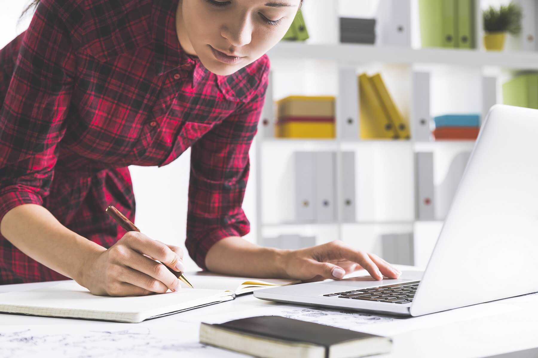 Serious designer in checkered dress working