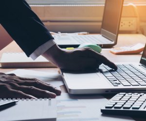 Business man working at office with laptop and documents on his desk