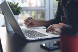 Business man working on laptop computer or student learning online at home office