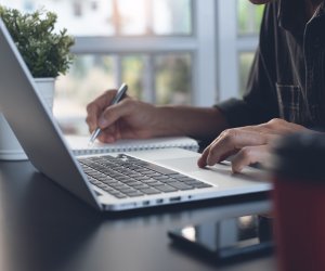 Business man working on laptop computer or student learning online at home office